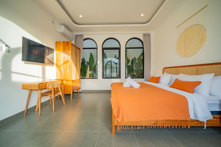 malea-Bedroom Orange Chairs Arched Windows